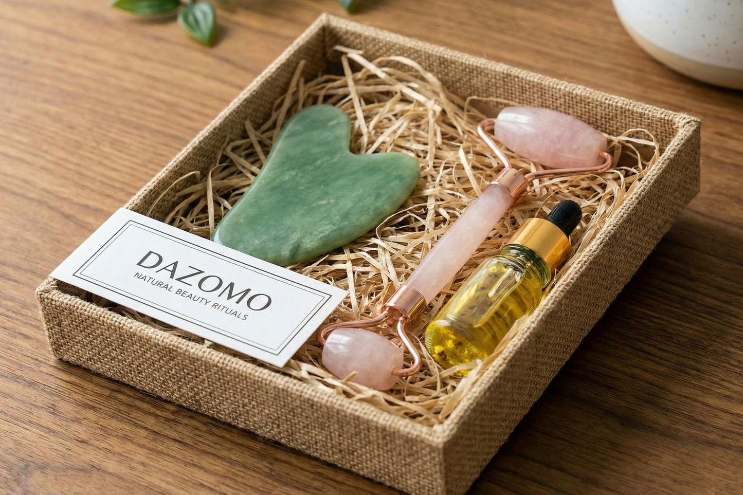 A DAZOMO Gua Sha Set containing a gua sha, facial roller, and facial oil.