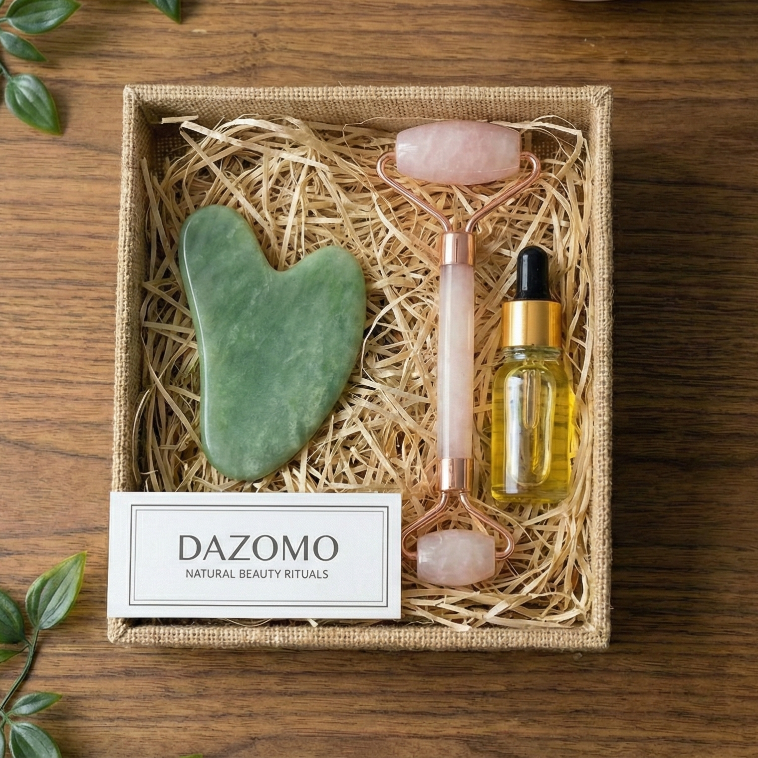 A DAZOMO Gua Sha Set containing a gua sha, facial roller, and facial oil.