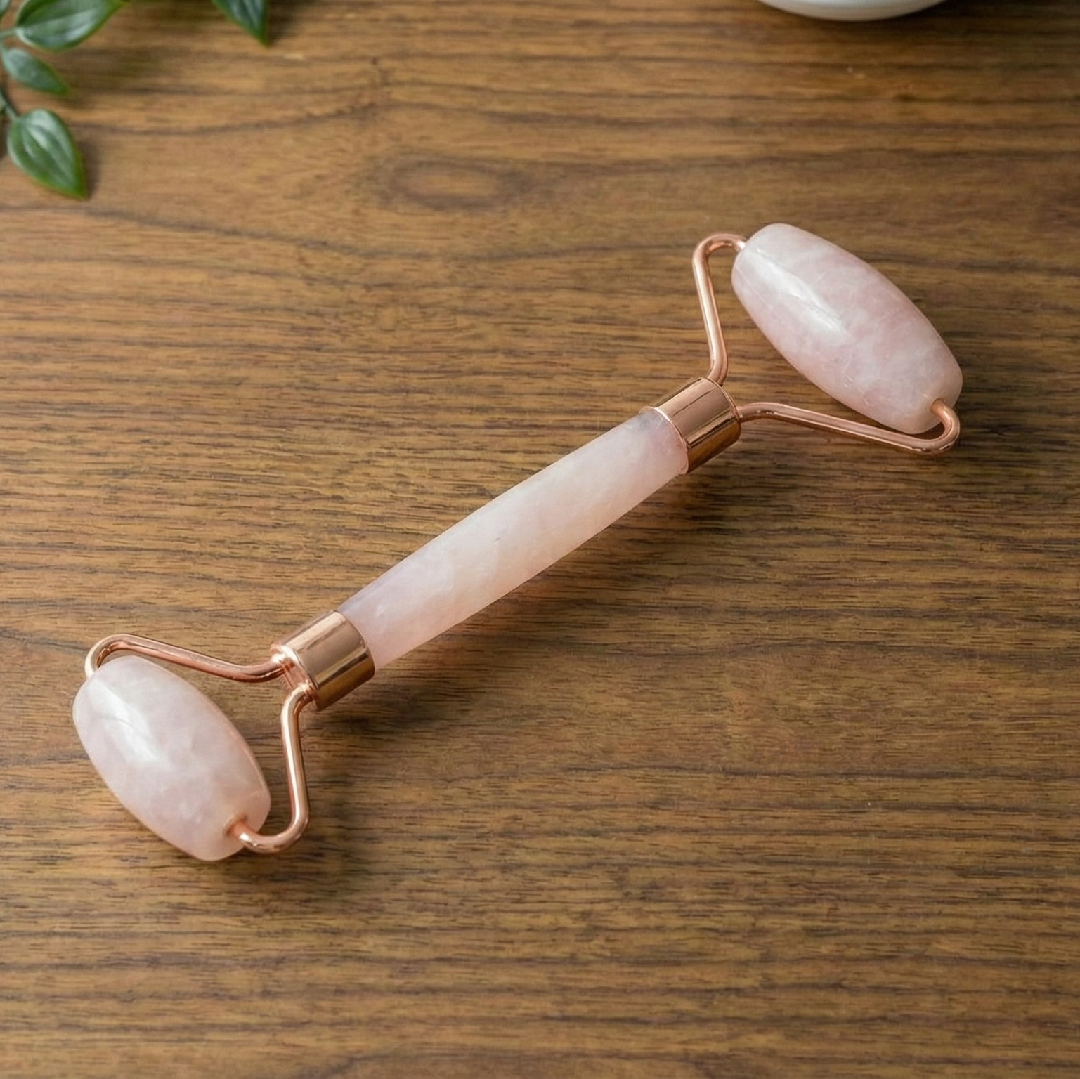A rose quartz facial roller.